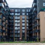 Contemporary apartment building facade with balconies in an urban setting.