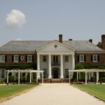 Elegant Southern-style mansion with white columns and lush gardens in Mount Pleasant, SC.